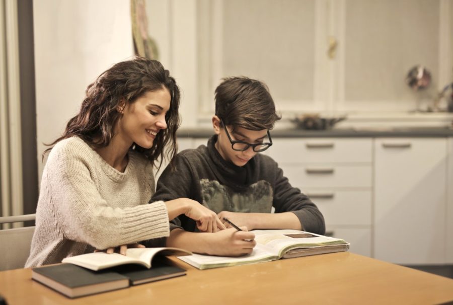 Mother helping son with homework.
