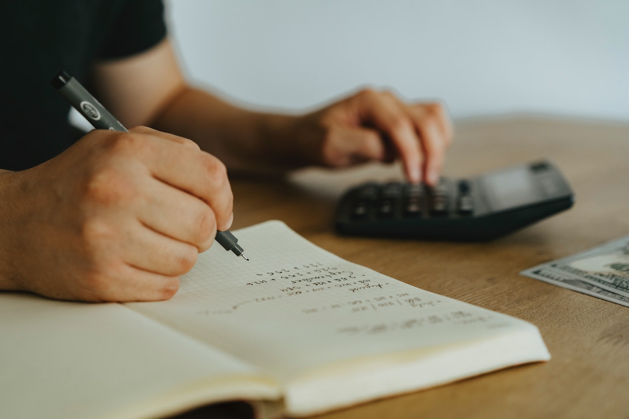 Man using calculator to file taxes.